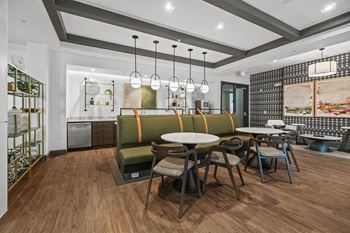 A modern dining area with a wooden floor and a green sofa at 1010 Dilworth Apartments, Charlotte, North Carolina
